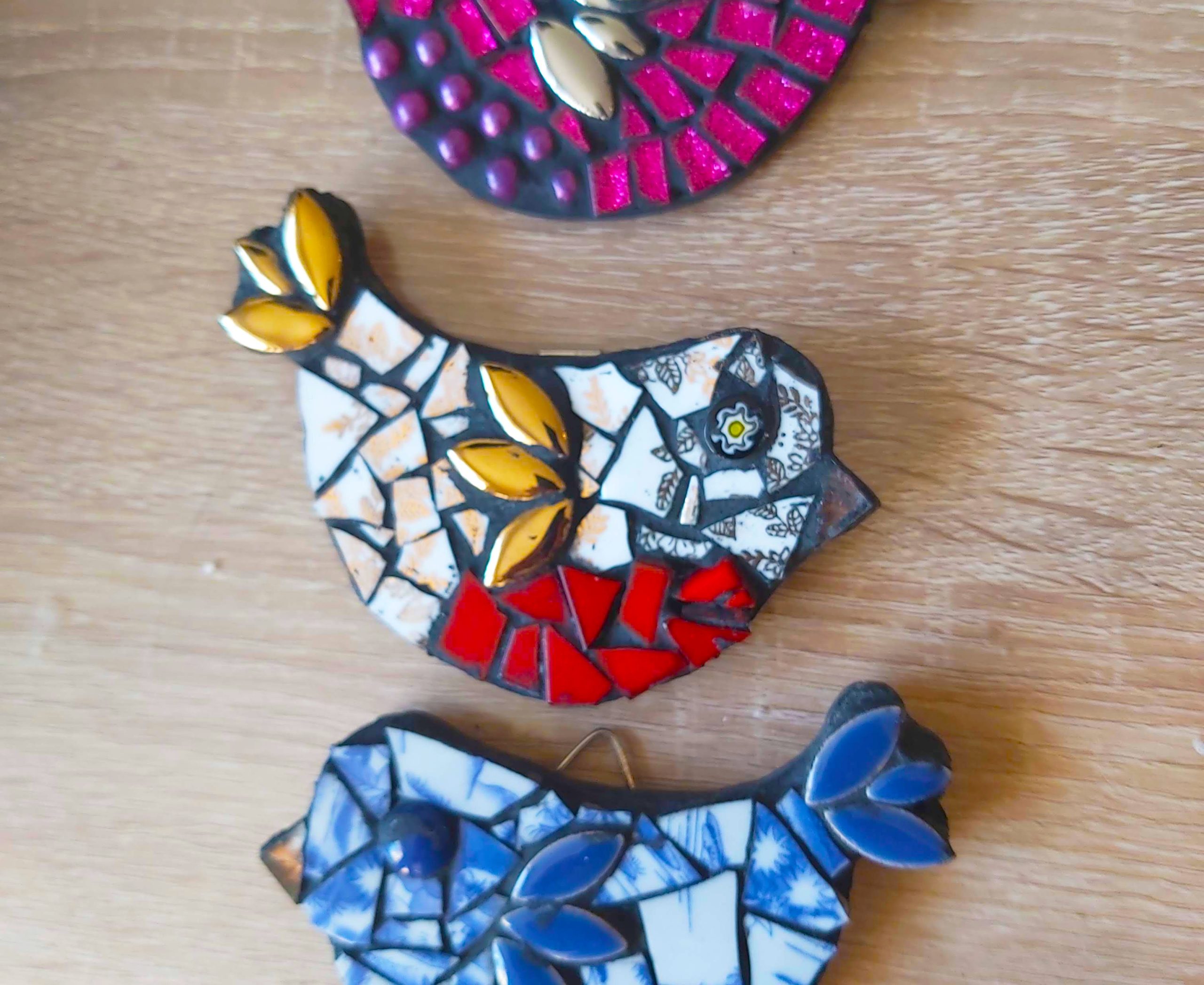 Bird shapes made out of colourful mosaic tiles.