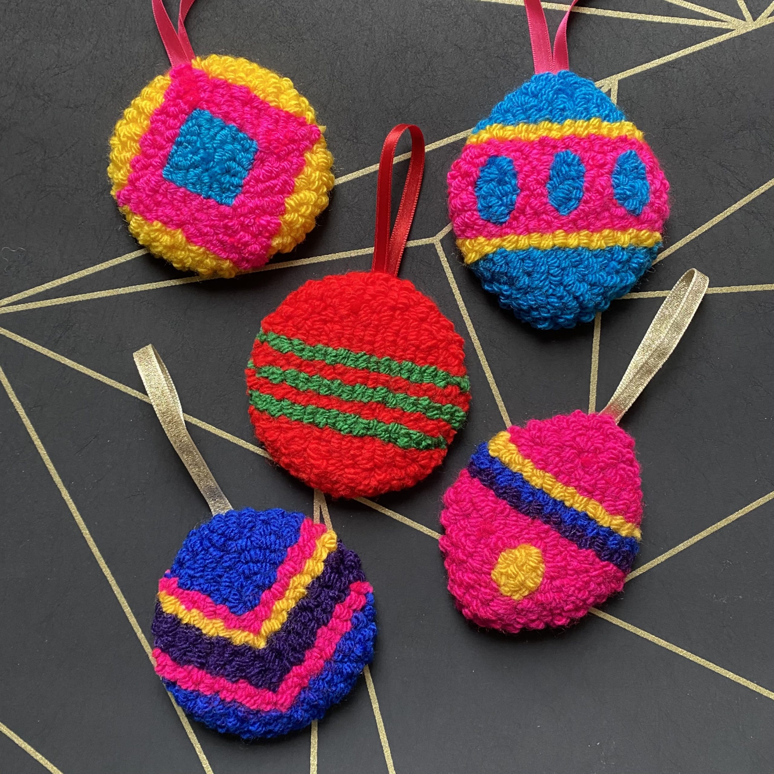 Colourful baubles made from yarn.