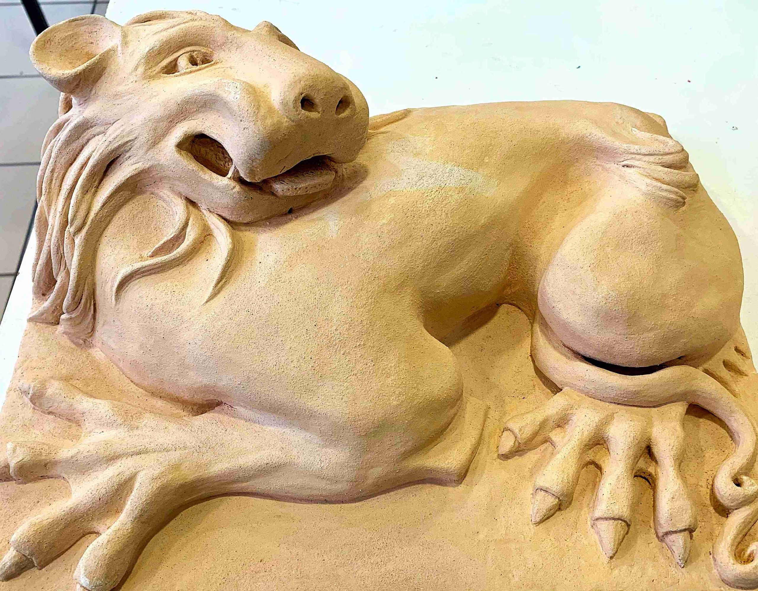 A clay sculpture of a lion.